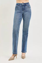 Blue jeans worn by a person on a light gray background