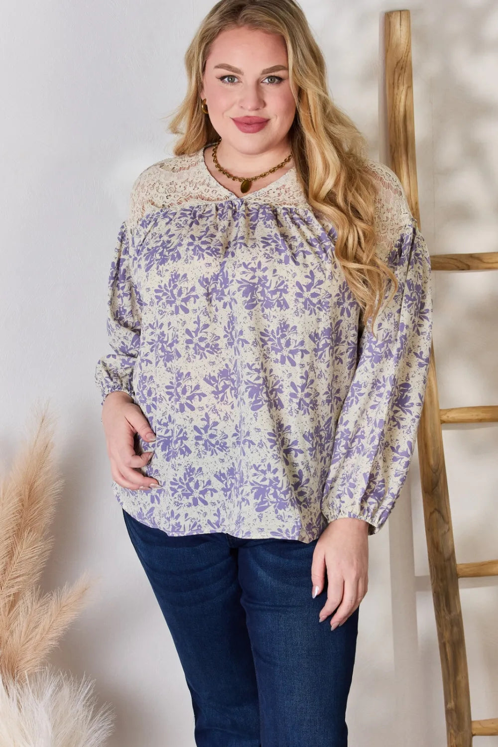 Woman wearing a floral blouse with a neutral background