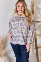 Woman wearing a floral blouse with a neutral background