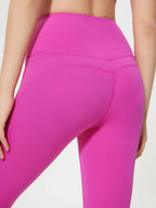 Close-up of bright pink leggings on a neutral background