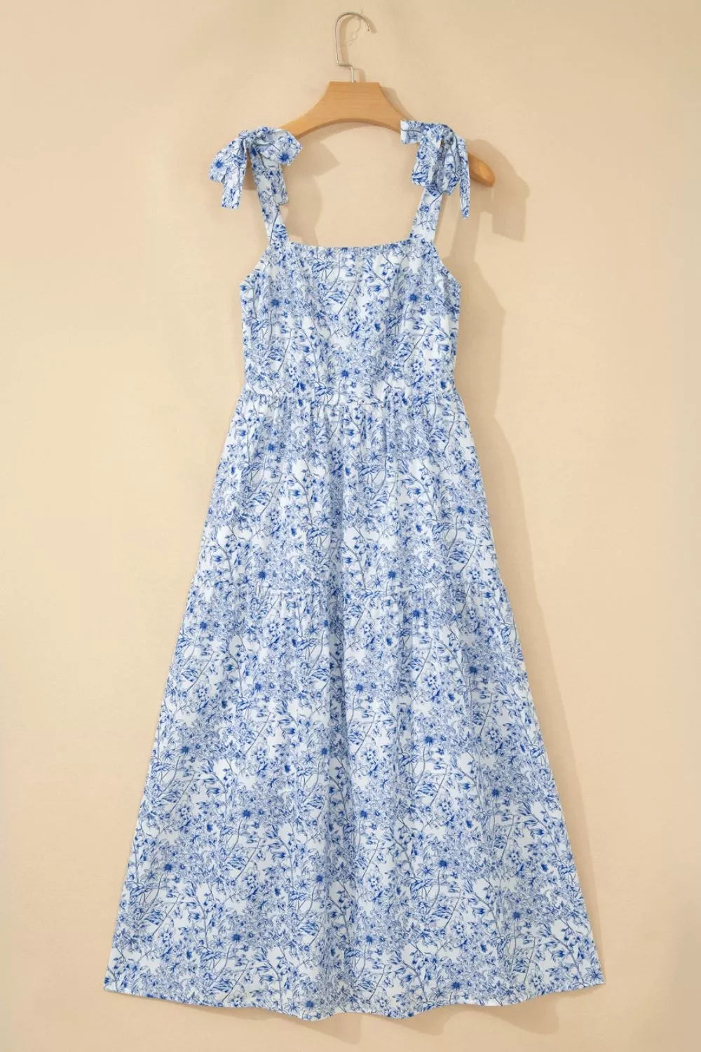 Blue floral dress on a beige background