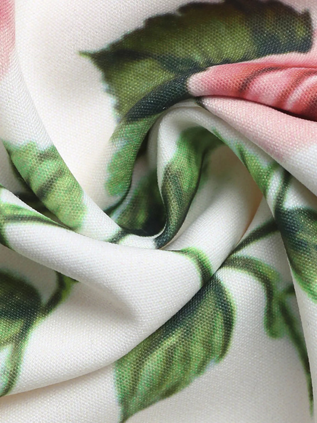 Close-up of fabric with green leaf pattern on a white background