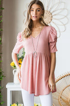 Woman wearing a pink dress with a decorative background