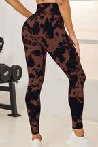 Person wearing brown tie-dye leggings in a gym setting