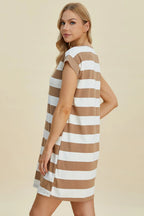 Woman wearing a brown and white striped dress on a beige background