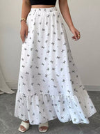 White skirt with black patterns worn by a person on a neutral background
