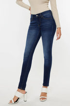 Person wearing blue jeans on a white background