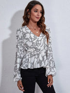 Woman wearing a patterned blouse against a plain background