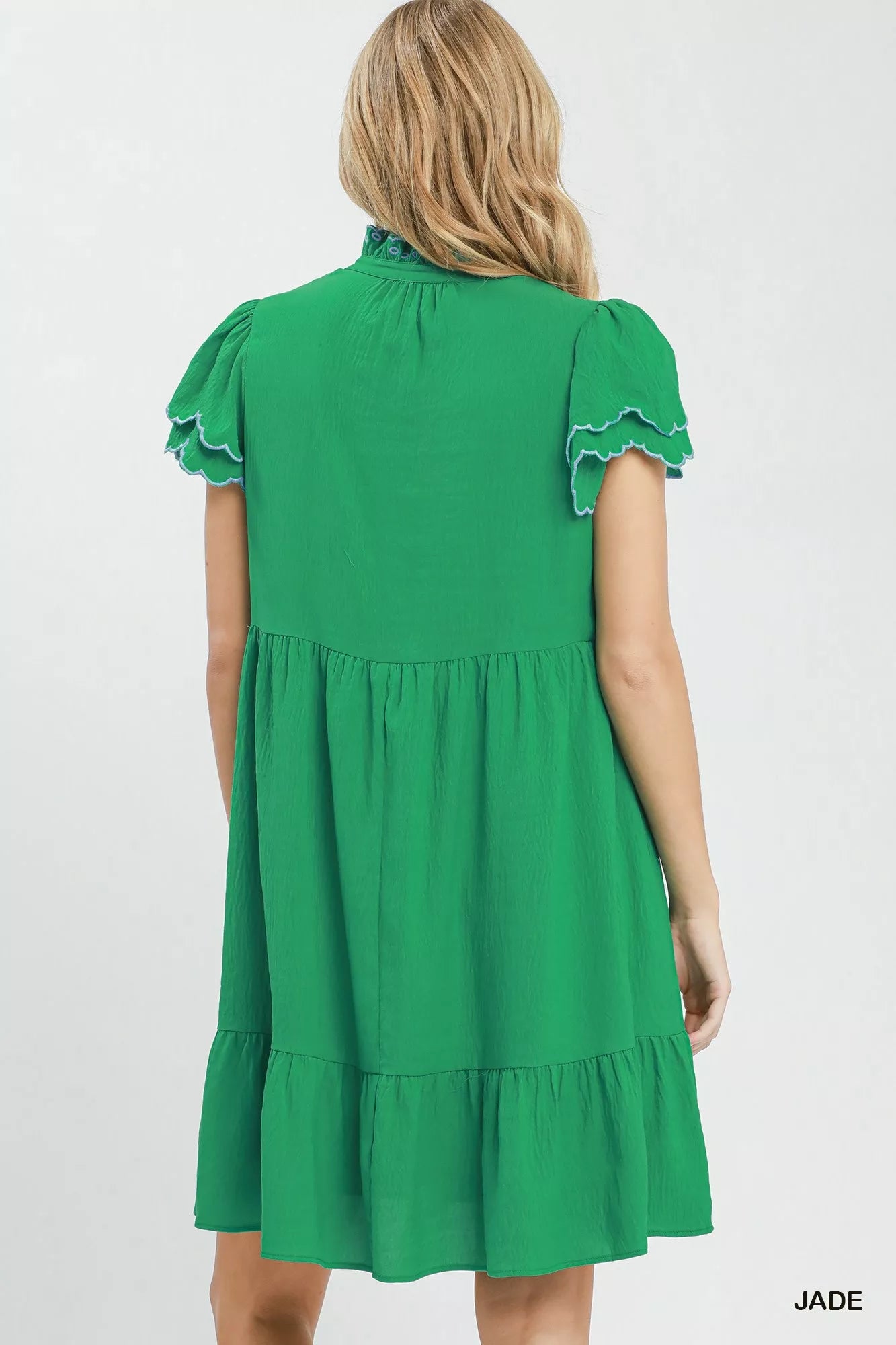 Green dress with ruffled sleeves on a white background