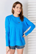 Woman wearing a blue sweater against a white background