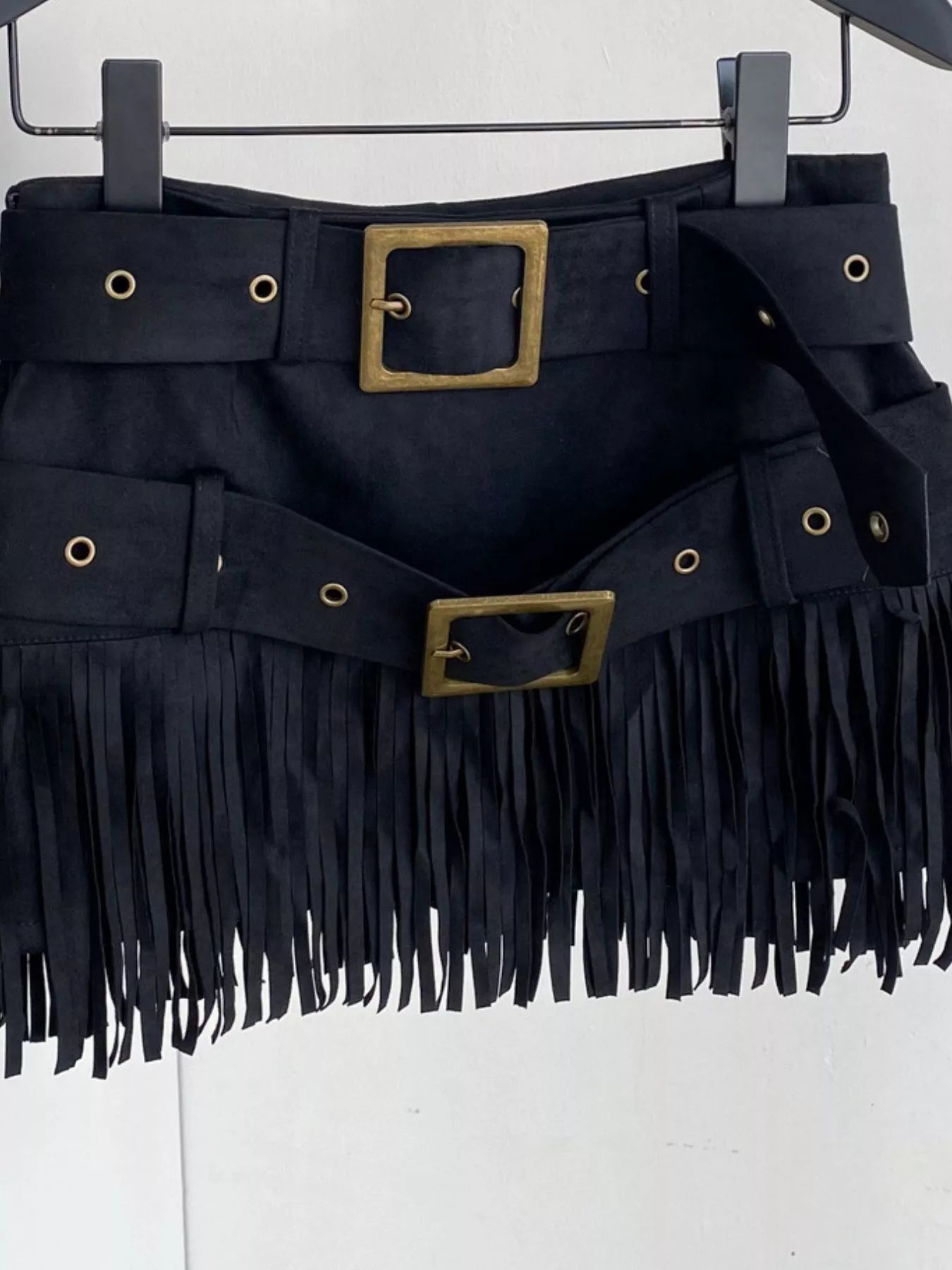 Black fringe belt with gold buckles on a white background