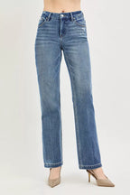 Blue jeans worn by a person on a light gray background