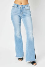 Light blue flared jeans on a white background