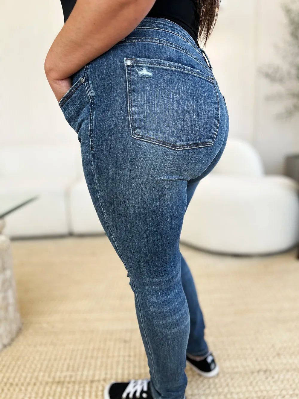 Person wearing blue jeans with a blurred background