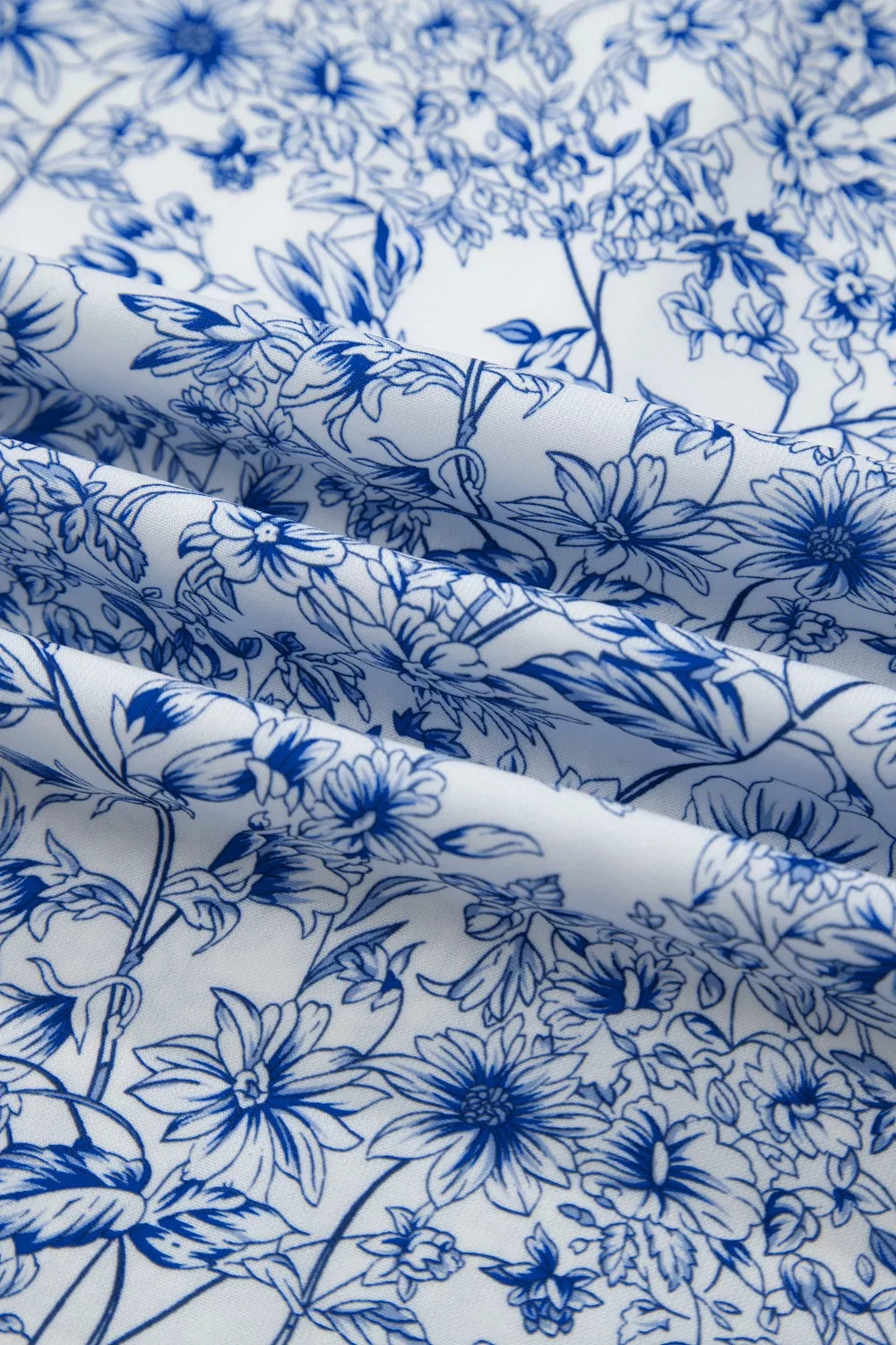 Close-up of blue floral pattern on white fabric