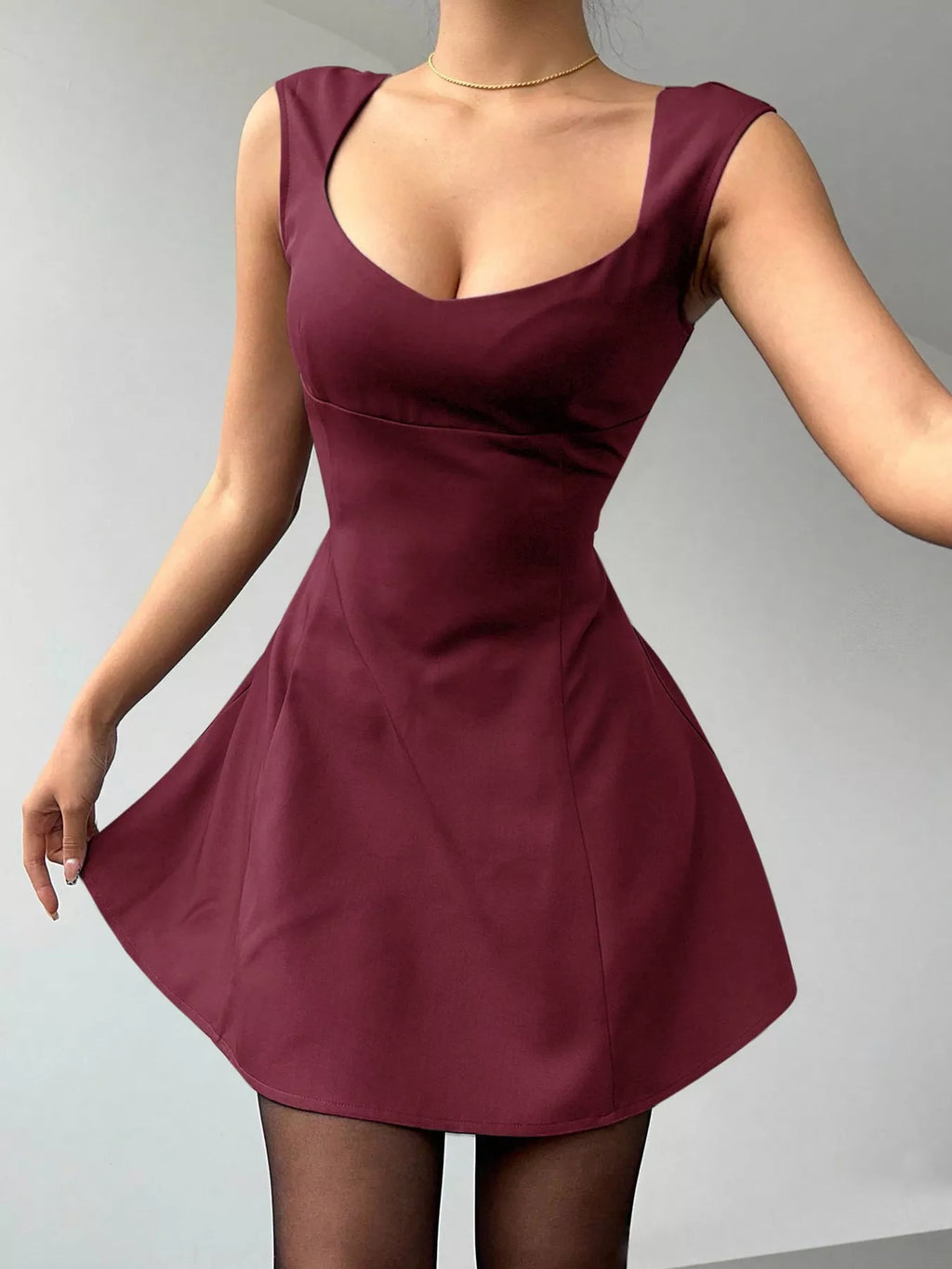 Maroon dress worn by a person on a gray background