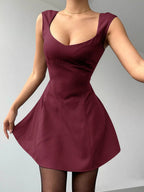 Maroon dress worn by a person on a gray background