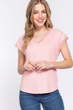 Woman wearing a pink top and blue jeans on a white background