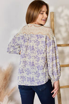 Woman wearing a floral blouse with a neutral background