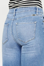 Close-up of blue jeans with a striped shirt underneath