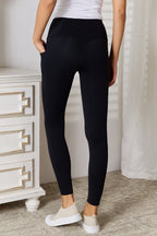 Person wearing black leggings with a white background