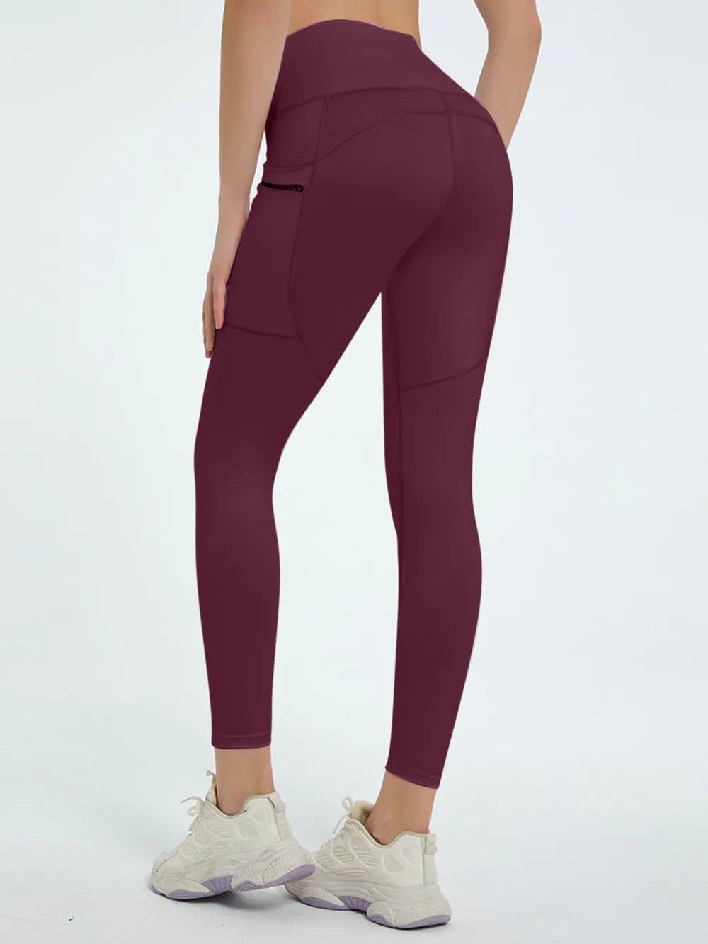 Maroon leggings worn by a person on a white background