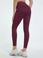 Maroon leggings worn by a person on a white background