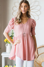 Woman wearing a pink dress with a neutral background