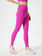 Person wearing bright pink leggings on a white background