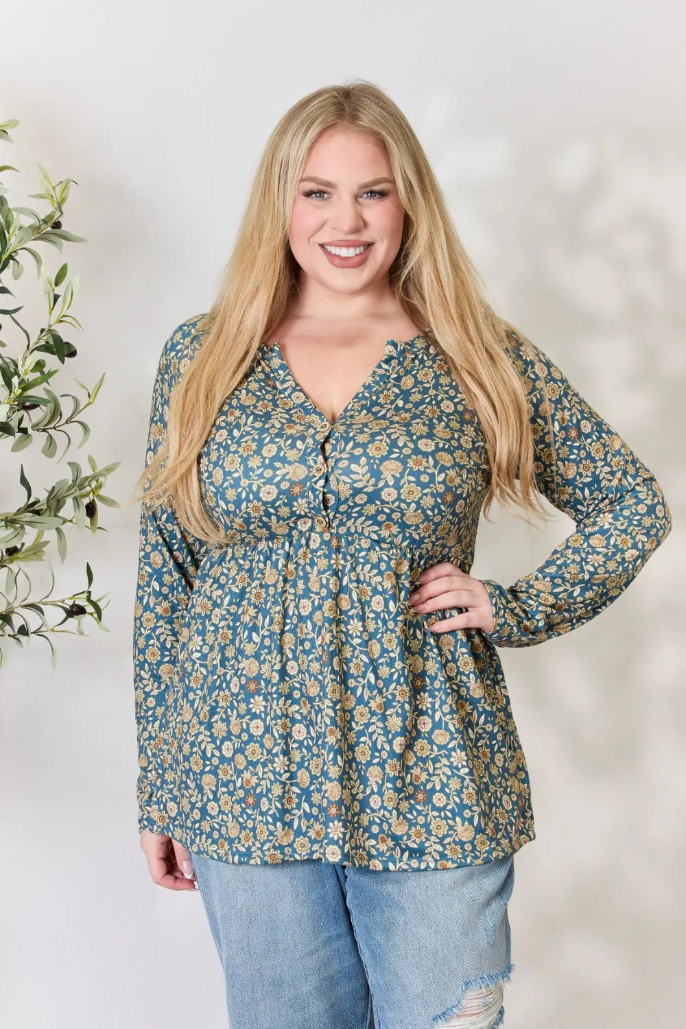 Woman wearing a floral blouse with a white background