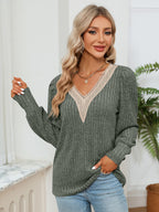 Woman wearing a green sweater with lace neckline in a home setting