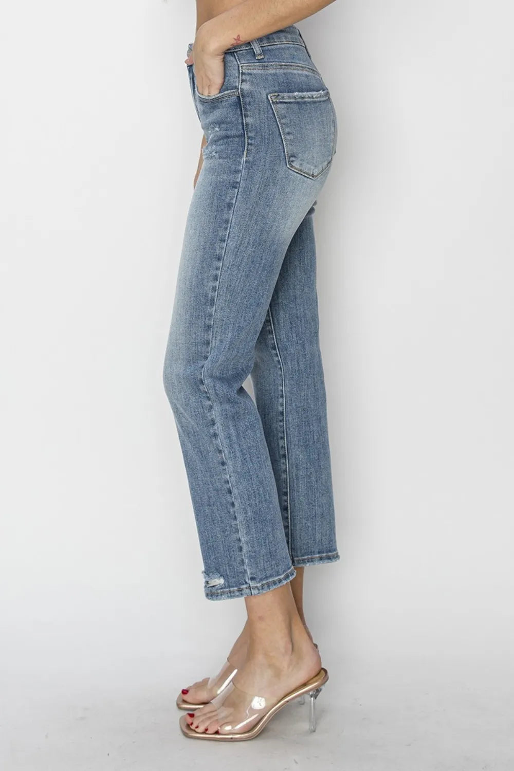 Light blue jeans worn by a person on a white background