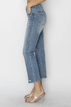 Light blue jeans worn by a person on a white background