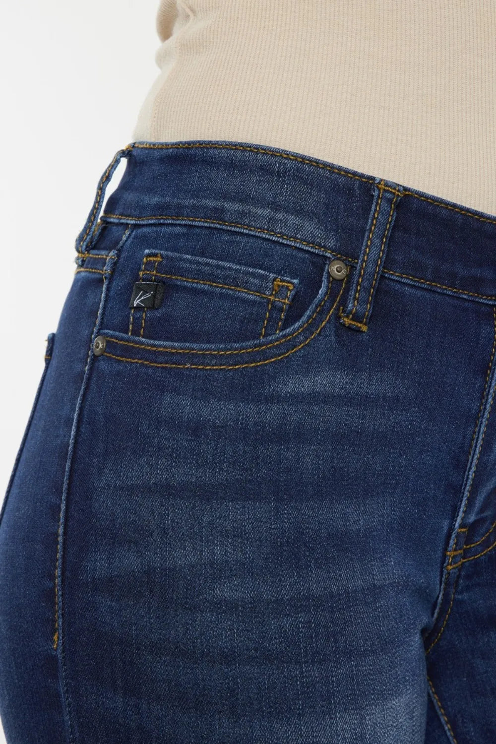 Close-up of blue jeans with a plain background