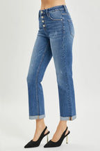 Blue jeans worn by a person on a white background