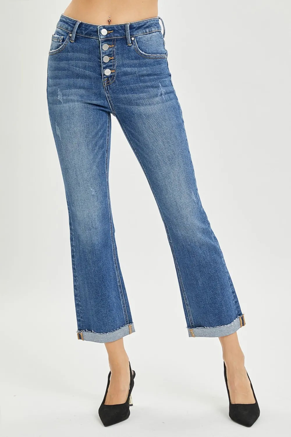 Blue jeans worn by a person on a white background
