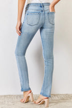 Light blue jeans worn by a person against a plain background