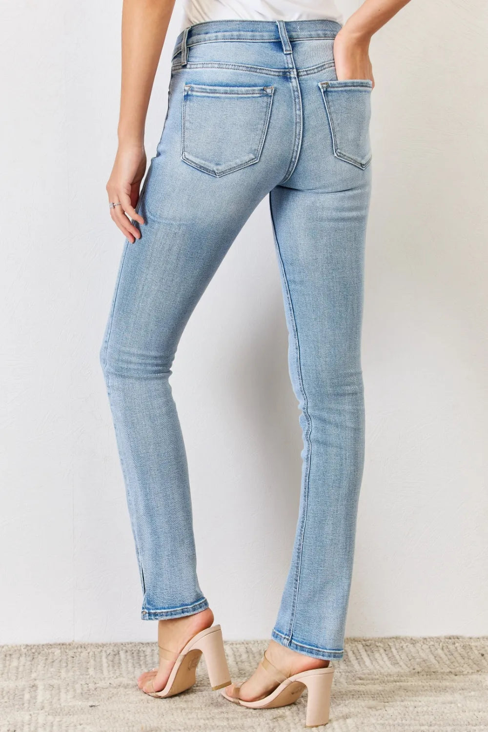 Light blue jeans worn by a person against a plain background
