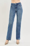 Blue jeans worn by a person on a light gray background
