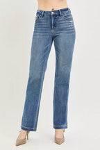 Blue jeans worn by a person on a light gray background