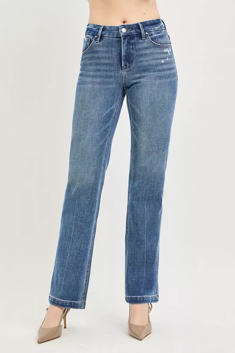 Blue jeans worn by a person on a light gray background