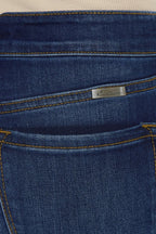 Close-up of a blue denim pocket with a brand label.