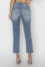 Blue jeans worn by a person on a white background