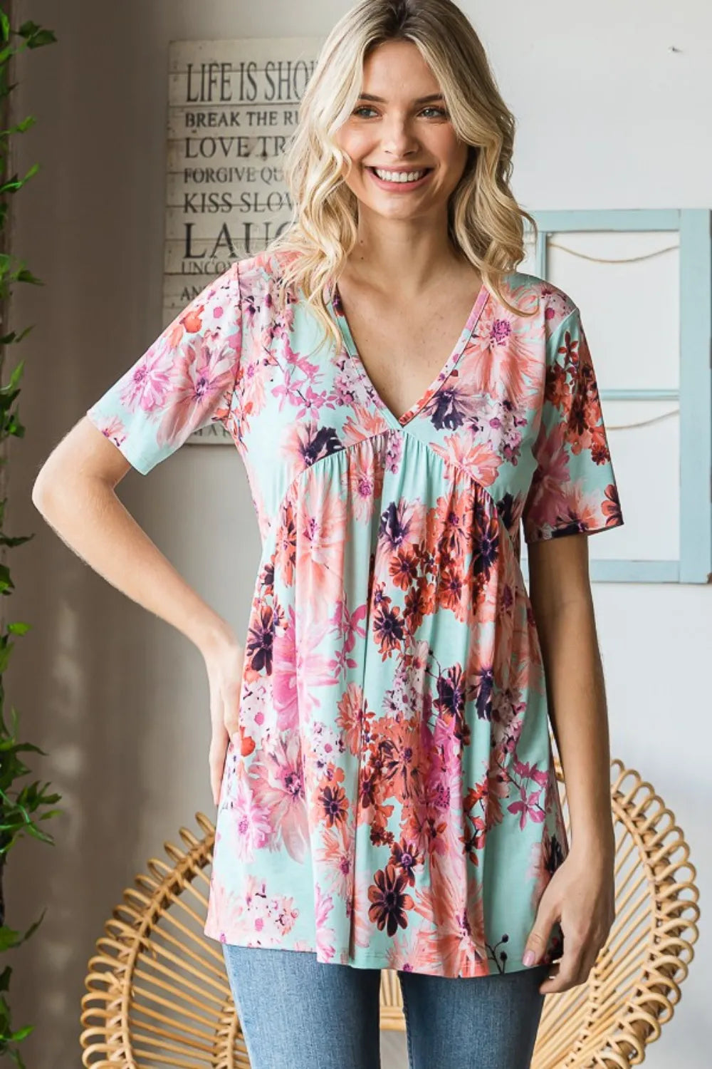 Woman wearing a floral print top in a home setting