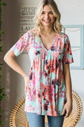 Woman wearing a floral print top in a home setting