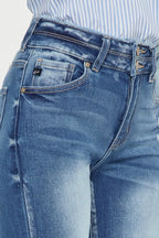 Close-up of blue jeans with a focus on the waistband and front pocket.