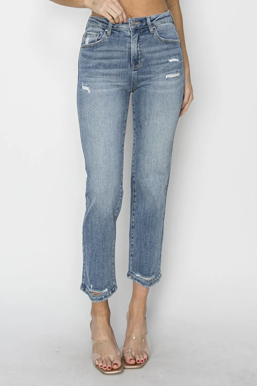 Blue jeans worn by a person on a white background