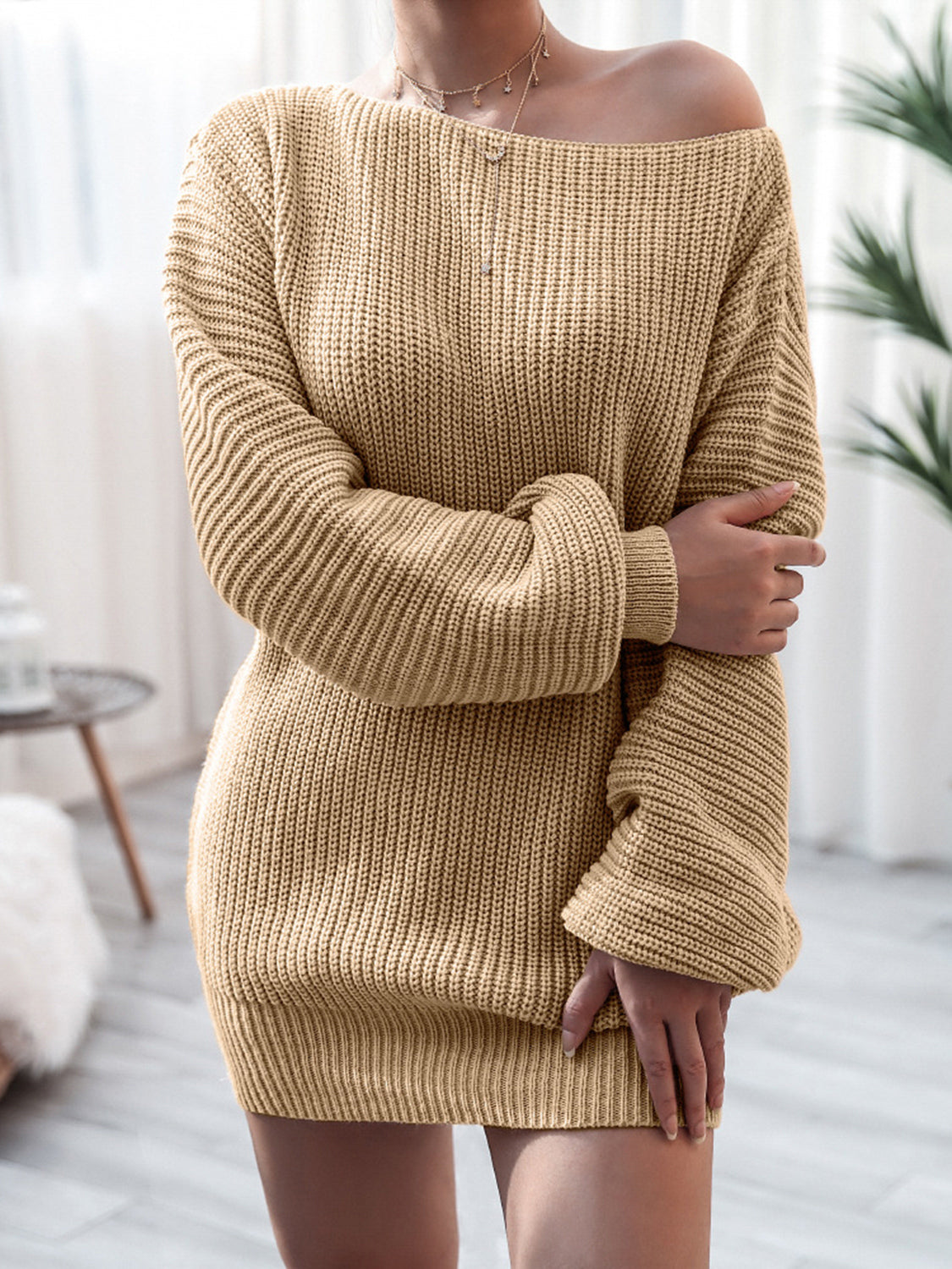Beige knitted dress worn by a person in a minimal indoor setting