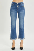 Blue jeans with a button fly on a white background