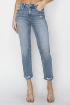 Person wearing light blue jeans on a white background